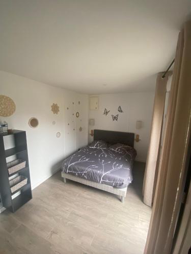 a bedroom with a bed in the corner of the room at Escale sous le hêtre in Ploumilliau