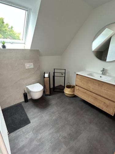 a bathroom with a toilet and a sink at La parenthèse in Artolsheim