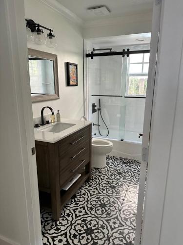 a bathroom with a sink and a toilet and a shower at Northwood Revival in West Palm Beach