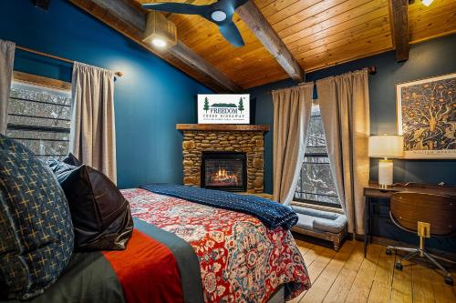 a bedroom with a bed and a fireplace at Freedom Creek Hideaway-Veteran Host-Pet Friendly-Single nights-Newly Renovated!! in Pigeon Forge