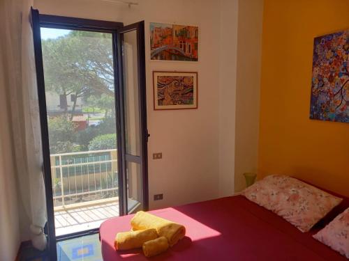 a bedroom with a bed and a large window at Sole in Quartu Sant'Elena