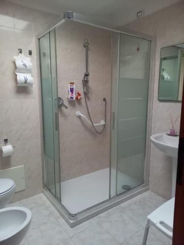 a shower with a glass door in a bathroom at Sole in Quartu Sant'Elena