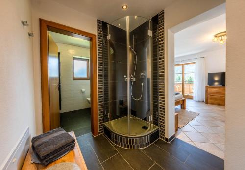 a bathroom with a shower with a glass door at Haus Lara - Fewo 2 in Wallgau