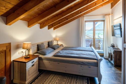a bedroom with a large bed and a window at Haus Lara - Fewo 3 in Wallgau
