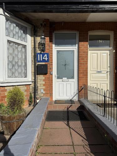 a house with a white door and a sign on it at Diamonds Guest House in York