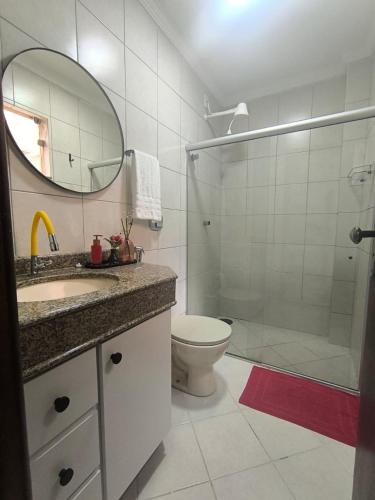 a bathroom with a shower and a sink and a toilet at Morada Vermelha in Vitória da Conquista