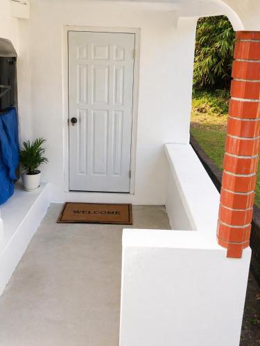 a white door with a mat in front of it at BtC Apartments St Paul's in Saint Paulʼs