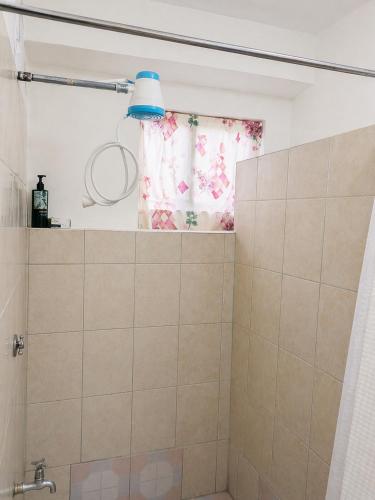 a bathroom with a shower with a blue light at BtC Apartments St Paul's in Saint Paulʼs