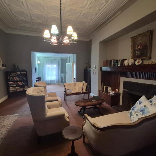 a living room with a couch and a fireplace at Kleingeluk Guest Cottages in Louis Trichardt