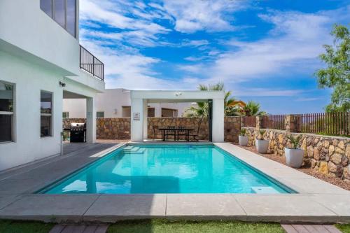 a swimming pool in the backyard of a house at Mountain View Pool House Villa in El Paso
