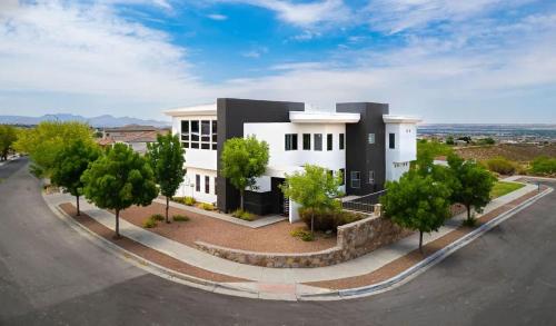 a large white building with trees in front of it at Mountain View Pool House Villa in El Paso