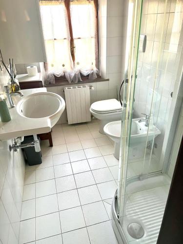 a bathroom with a sink and a toilet and a shower at Casa del Sole in Gambassi Terme