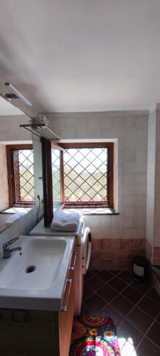 a bathroom with a sink and a mirror at Guesthouse Acherusia in Bacoli