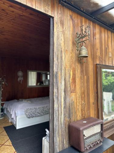 a bedroom with a bed and an open door with a mirror at Le Chalet de Marie France in Combs-la-Ville