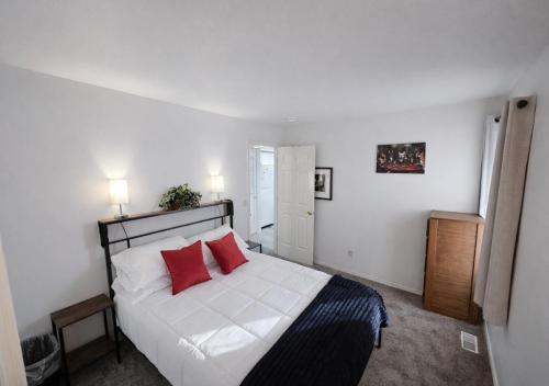 a bedroom with a white bed with two red pillows at Passive Stays Mountain Home 2BR in Mountain Home