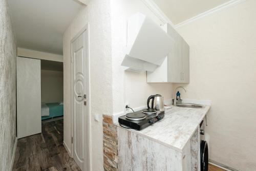 a kitchen with a sink and a counter top at Studio Room Central in Chişinău