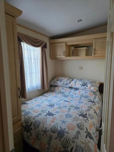 a small bedroom with a bed in an rv at Westwood Hide Away in Allhallows