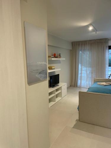 a bedroom with a bed and a television in it at Sophia's studio in Saronida