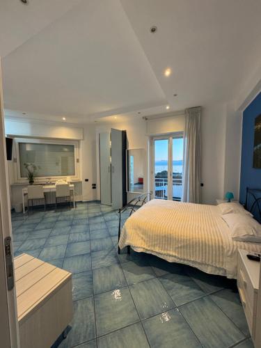 a bedroom with a bed and a living room with a table at Blue Sea Salerno in Salerno
