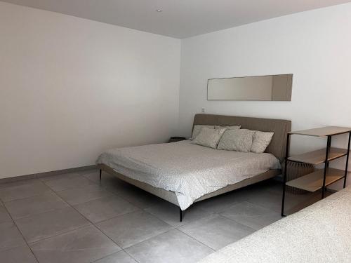 a bedroom with a bed and a side table at Garou in Luxembourg
