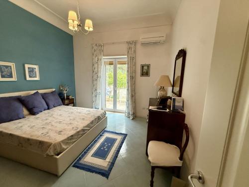 a bedroom with a bed and a mirror and a chair at Villa due rami in Anacapri