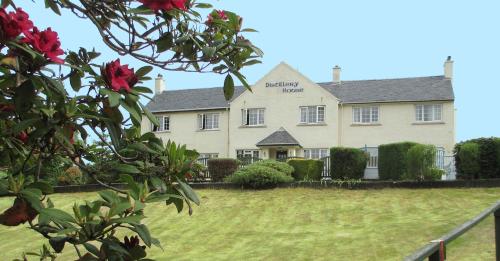 a large white building with a yard in front of it at Distillery Guest House in Fort William