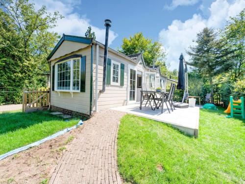 a tiny house with a picnic table and a playground at Chalet in Stegeren near Hiking Trails in Stegeren