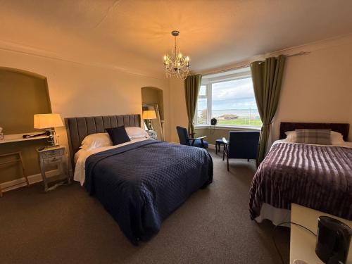 a hotel room with two beds and a window at "SUPERB-SEA-VIEWS"ROOM ONLY at WETHERBY NAIRN in Nairn