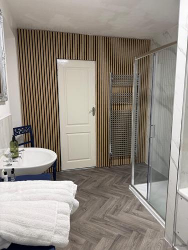 a bathroom with a shower and a sink and a door at "SUPERB-SEA-VIEWS"ROOM ONLY at WETHERBY NAIRN in Nairn