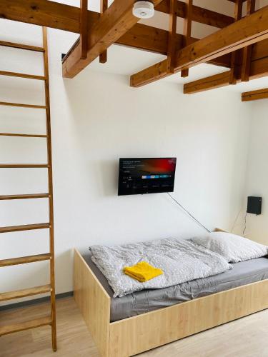 a bedroom with a bed with a tv on the wall at Monteur Apartment Lingen Zentrum in Lingen