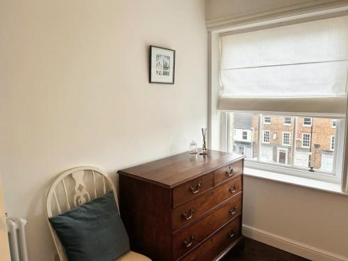 a bedroom with a dresser and a window at Clubhouse 3 in Bedale