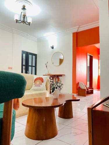 a living room with a couch and a table at Rieti Yamehome in Yaoundé