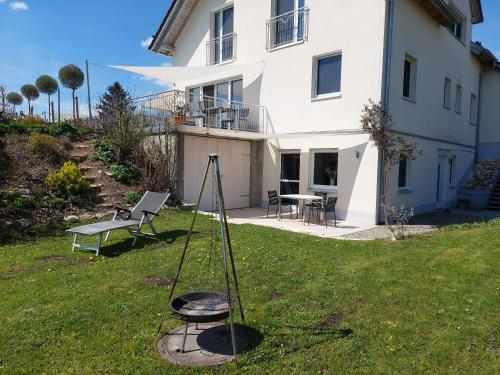 a tripod in the grass in front of a house at Apartment in Stetten bei Mindelheim in Stetten