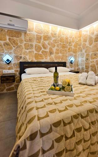 a hotel room with a bed with a tray of fruit on it at Casa Bella a Skala 1 in Skala