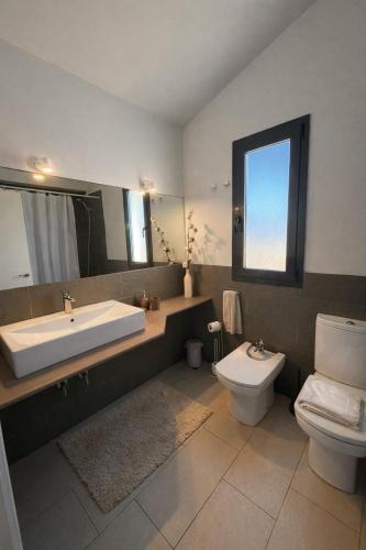 a bathroom with a sink and a toilet at Villa Son Blanc 5 in Sa Caleta