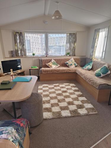a living room with a couch and a table at Ollys House in Prestatyn
