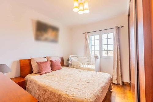 a small bedroom with a bed and a window at The Refuge Mosteiros house in Mosteiros