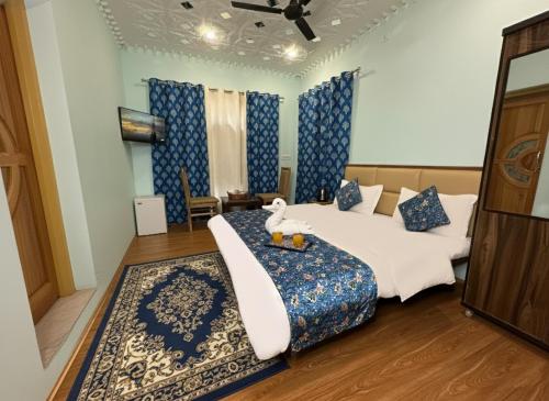 a hotel room with two beds with a teddy bear sitting on thevisor at Faizzy residency in Srinagar