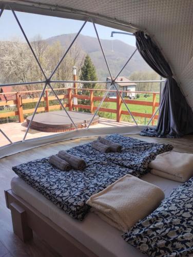 a bed in a tent with a large window at MB Glamp in Międzybrodzie Bialskie
