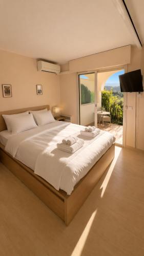 a bedroom with a large bed with a large window at French Riviera Golf in Mandelieu-La Napoule