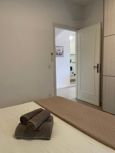 a room with a bed with two towels on it at Sea Rocks House in Olbia