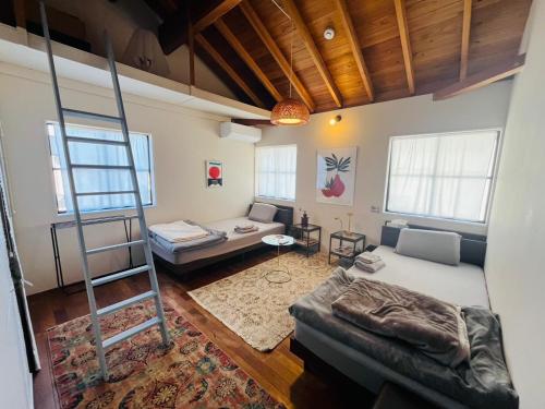 a living room with a ladder and a couch at AGASA residence in Fujieda