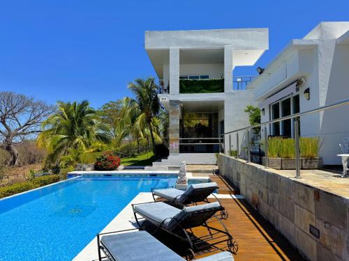 a villa with a swimming pool and a house at Lakeview Granada Hotel Boutique in Granada