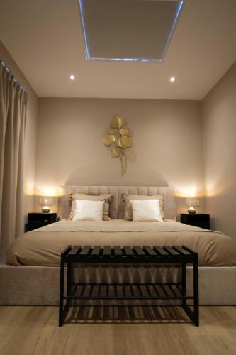 a bedroom with a large bed with a flower on the wall at Huize Zondag in Beneden-Leeuwen