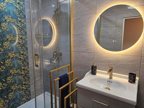 a bathroom with a sink and a shower at Szybowcowa View Apartment in Jelenia Góra