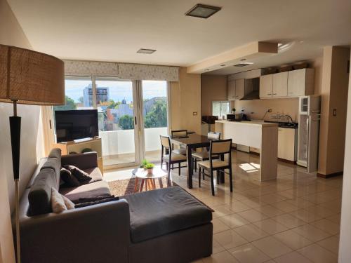 a living room and kitchen with a couch and a table at Piero House in Villa Mercedes