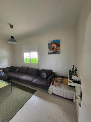 a living room with a couch and a table at your cute house in Salé