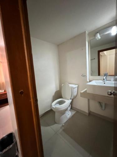ein Badezimmer mit Toilette, Waschbecken und Spiegel in der Unterkunft Hotel Sol del Pacifico in Lázaro Cárdenas