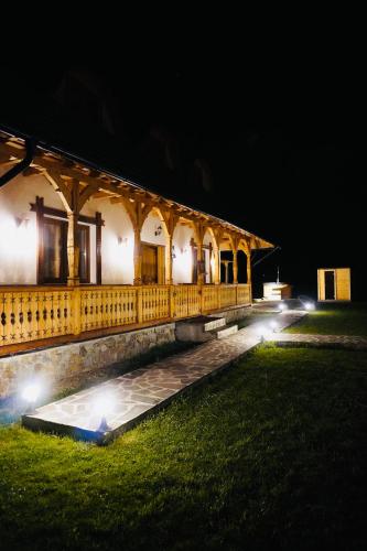 a building with lights in front of it at night at Casa Moroșanului Vișeu de Sus in Vişeu de Sus