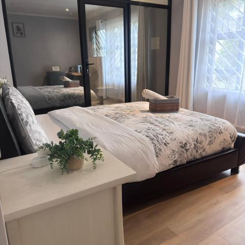 a bedroom with a large mirror and a bed at Terrys place in Malmesbury